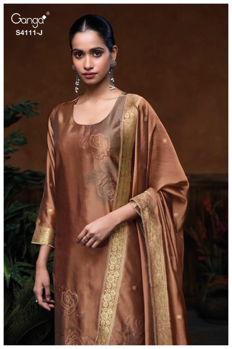 Woman wearing a brown traditional outfit with gold embroidery against a dark background
