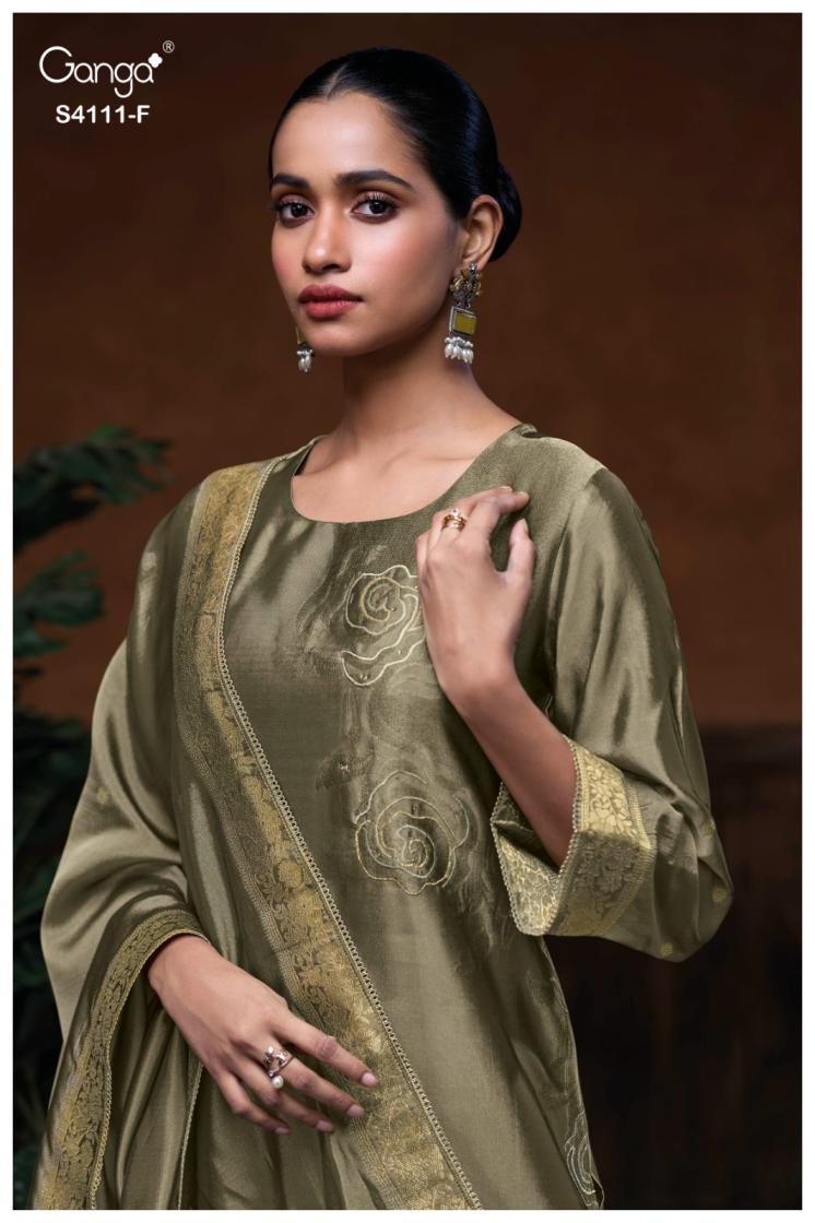 Woman wearing a green embroidered traditional outfit with a brown background
